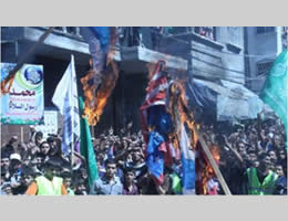 demonstrators burn United States and Israeli flags during a Hamas rally in the northern Gaza Strip (Felesteen al-Aan, September 14, 2012).