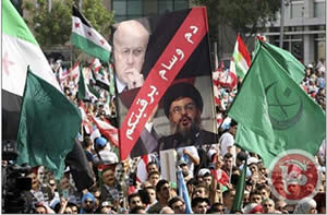 Mourners wave a banner accusing Hassan Nasrallah and Lebanese Prime Minister Miqati of responsibility for al-Hassan's assassination (Ma'an News Agency, October 21, 2012).