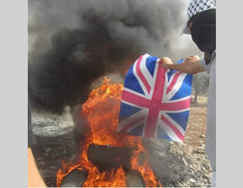 Demonstrators in the village of Qadoum burn the British flag (Facebook page of PALQA, November 2, 2012). 