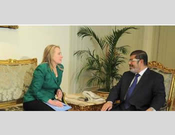 American Secretary of State Hillary Clinton and Egyptian President Mohamed Morsi discuss the terms of the ceasefire agreement (Mohamed Morsi's Facebook page, November 21,  2012).