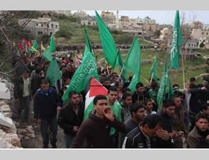 The funeral of Muhammed Samih Asfour in the village of Aboud, with mourners holding green Hamas flags (Paltoday website, March 8, 2013).