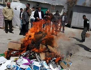 Products allegedly manufactured in the settlements and confiscated from Palestinian merchants are burned (Filastin Al-'Aan, March 11, 2013).