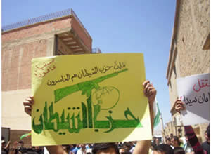 A poster carried by Hezbollah’s opponents in Lebanon