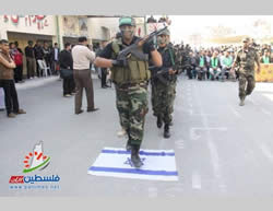 Gazan youths participating in the Al-Futuwwa Project march on Israeli flags (Filastin Al-'Aan, November 20, 2013). 