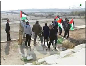 Palestinian activists plant flags in preparation for erecting Canaan Village 9 near the Dead Sea (Palestinian TV, January 1, 2014).