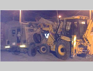 Vehicular attacks: The blade of the front loader slams into the roof of an IDF jeep (IDF Spokesman, October 17, 2013).