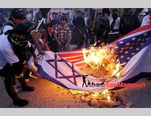 The Israeli and American flags burned at the PIJ rally (Hamas forum Facebook page, October 29, 2012).