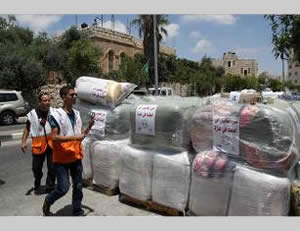 Left: Donations collected in Hebron for the Gaza Strip (Wafa.ps, August 3, 2014). Right: Donations collected at a school (PNN TV, August 2, 2014).