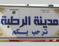 The sign at the entrance to Rutba showing the ISIS insignia (on the left) and the words “the Islamic State” 