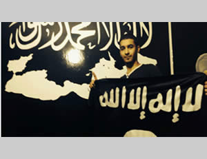 Karim Abu Saleh, one of the network operatives, against the background of an ISIS poster (Israel Security Agency, January 18, 2015)