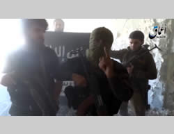 ISIS operatives against the background of an ISIS flag in the city of Al-Zabadani (YouTube, July 11, 2015)