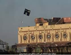 ISIS flag waving on the Al-Baraka Hotel in Baiji (Justpaste.it file-sharing website, August 22, 2015). 