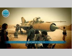 Al-Nusra Front operatives next to a Syrian fighter plane at the Abu al-Duhur military airbase (Twitter account affiliated with the Al-Nusra Front, September 10, 2015)