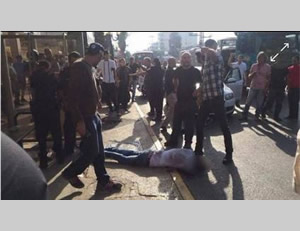 The injured terrorist stabber lies on the main street in Raanana