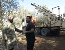 One of the Jaysh al-Fatah commanders near a truck belonging to a heavy artillery battery (YouTube, July 31, 2016)