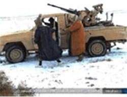 ISIS operatives near an off-road vehicle with an anti-aircraft gun on the outskirts of the T-4 military airfield. 