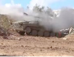 Syrian Army tank fires at the rebel forces in Manshiya. 