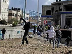 Palestinians throwing stones at Israeli security forces in Al-Ram