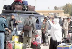 Palestinians wait at the Rafah crossing (Al-Ayam, February 20, 2011)