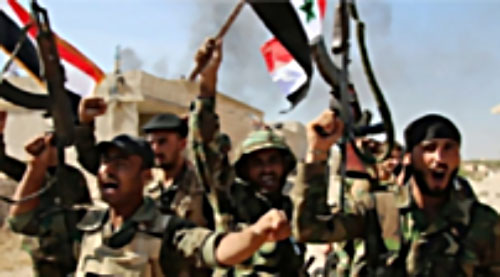 Syrian army soldiers wave Syrian flags and rifles after taking control of Deir al-Zor.