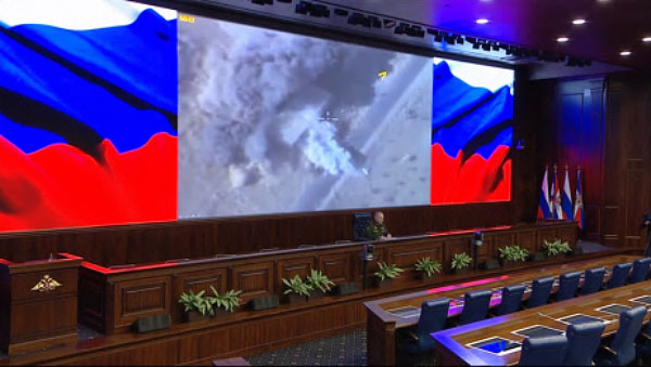 Sergey Rudskoy at the press conference. In the background, videos of the Russian airstrikes (website of the Russian Defense Ministry, December 7, 2017)