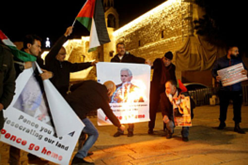 Palestinian activists in front of the Church of the Nativity in Bethlehem burn pictures of American Vice President Mike Pence (Twitter account of Palinfo, January 22, 2018).