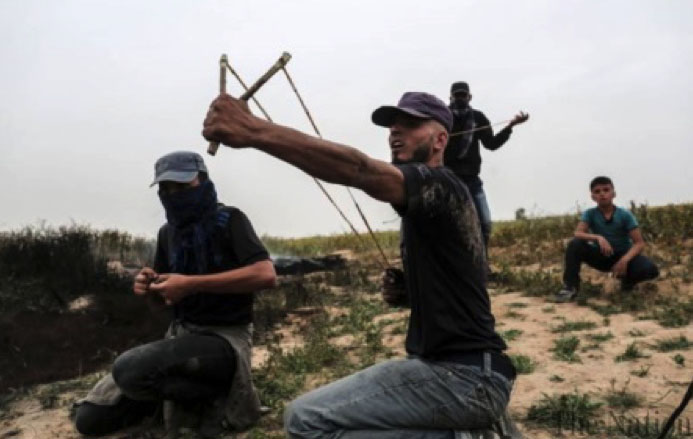 Palestinians riot near the border security fence in the Gaza Strip (Ma'an, March 23, 2018).