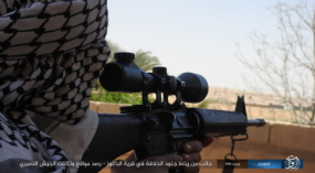 ISIS sniper observing Syrian army positions from the village of Al-Baghouz al-Fawqani.