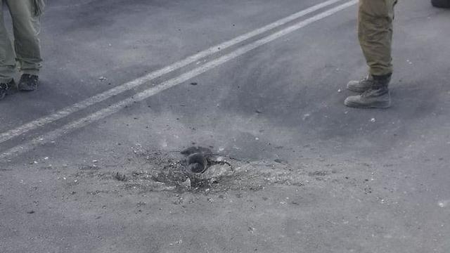 A rocket hit on a road (Israel Police Force spokesman's unit, June 20, 2018).