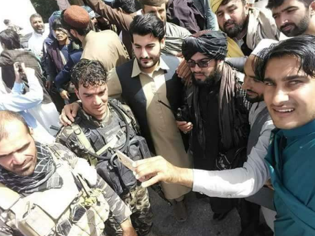 Taliban fighters and Afghan army soldiers celebrating the ceasefire in Afghanistan together (Haqq, June 16, 2018)