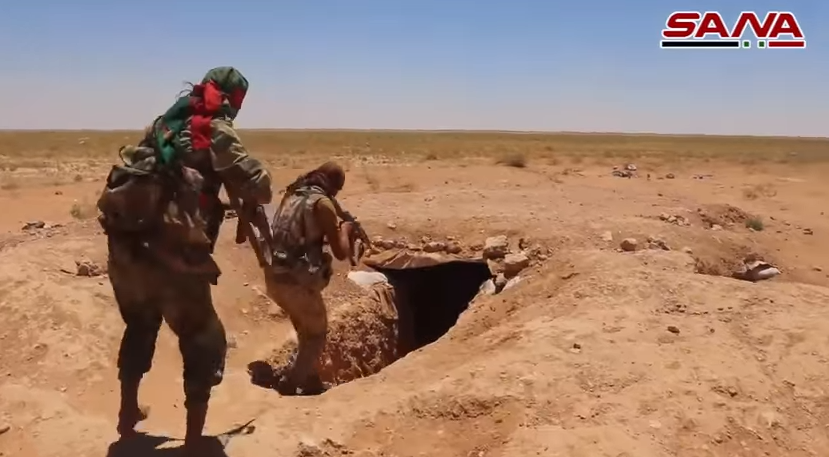 Fighters (apparently belonging to the Palestinian Al-Quds Brigade) searching a trench and a cave previously used by ISIS (SANA, June 20, 2018)