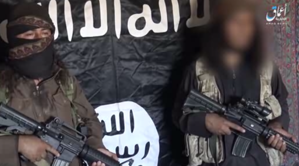 Two ISIS operatives next to the ISIS flag. The operative on the right (whose face has been blurred) is presenting the Iraqi government with an ultimatum (www.k1falh.ga, June 23, 2018).