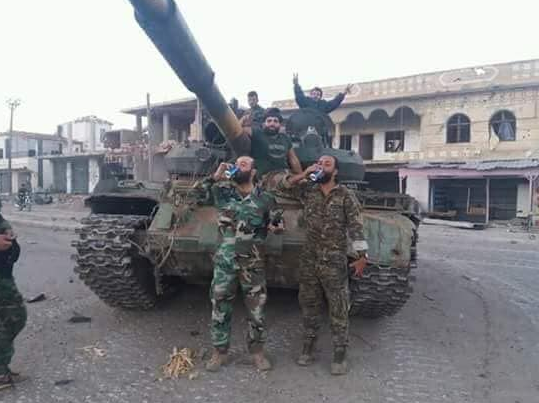 Fighters from the Syrian army and the Dhu al-Fiqar Brigade in a victory photo in Busra al-Harir.