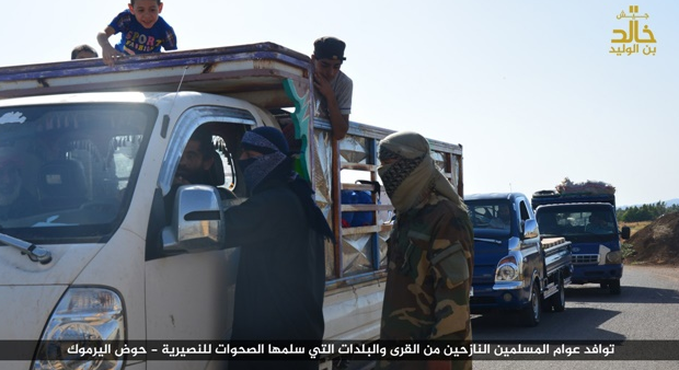 Displaced persons arriving in the area controlled by the Khaled bin Al-Walid Army in the Yarmouk Basin, where the organization operatives stop them for checking. 