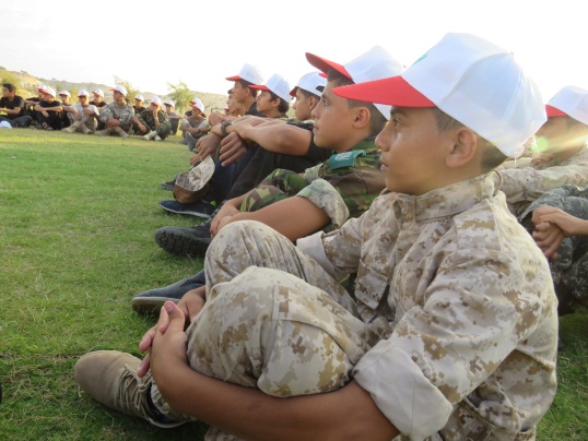 The first day of the "Pioneers of Liberation" camp at the al-Qadissiya post in the Khan Yunis district (Facebook page of Hamas' central committee for summer camps, August 6, 2018). The sitting instructor is uniformed and apparently a military operative.