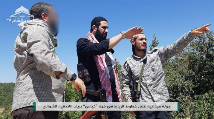 Abu Mohammad Al-Julani (center, in black), commander of the Headquarters for the Liberation of Al-Sham, during a visit to the organization’s defense lines at the summit of the Kabani Mountain, the Kurds’ Mountain (northeast of Latakia). 