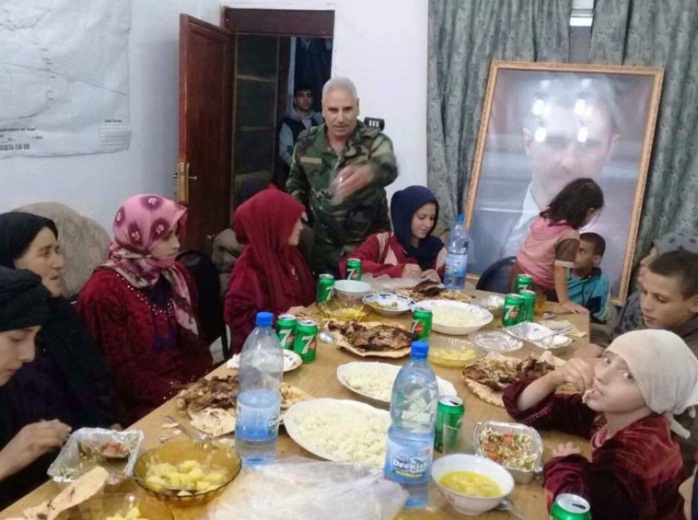 The released Druze abductees together with their children, with a large photo of Syrian President Bashar Assad in the background (Furat Post Facebook page, November 8, 2018). 