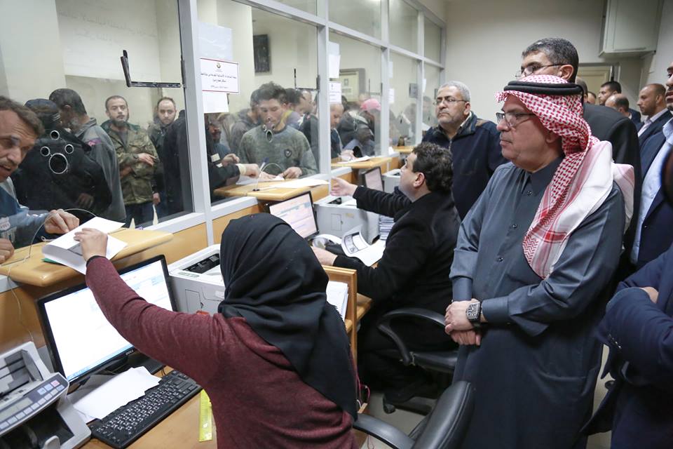 Muhammad al-Amoudi visits a post office in the Gaza Strip to watch the distribution of funds from Qatar. 