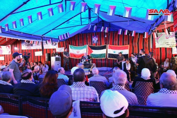 Palestinian and Iranian flags behind the speakers' dais at the Jerusalem Day events in Damascus (Sana, May 31, 2019). 