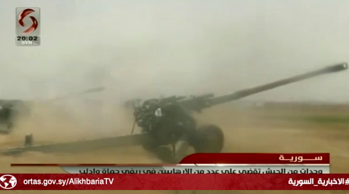 Syrian army artillery fire at operatives of the Headquarters for the Liberation of Al-Sham and the Battalions of Glory on the road between Tal Malah and Wadi Othman (Al-Ikhbariya Channel, Syria, June 29, 2019)