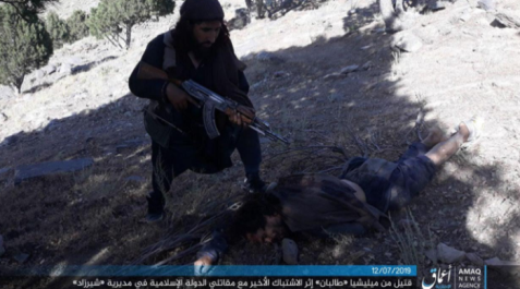 ISIS operative near the body of a Taliban man killed during the attack in the Wadi Hasar area of the Nangarhar Province (Telegram, July 12, 2019). 