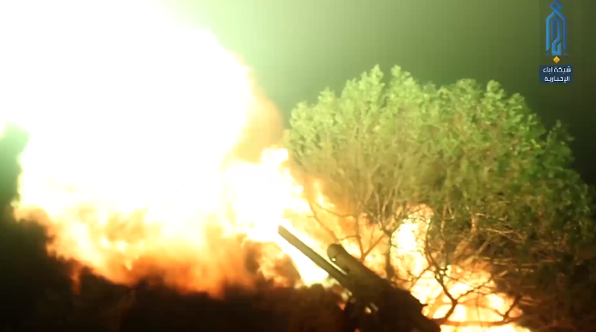 Field gun of the Headquarters for the Liberation of Al-Sham fires at Syrian army positions in Al-Qasabiya before the attack (Ibaa, July 21, 2019).