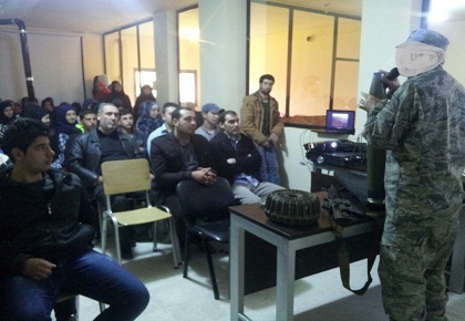 Hezbollah operative explaining about various types of weapons during a meeting with students and lecturers in the Al-Massar academic institute in the village of Al-Lubuwwa in the Bekaa Valley (Education Mobilization website, no date). 