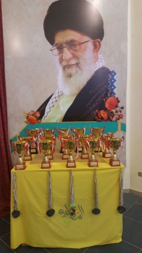 A martial arts event dedicated to the “Shahids of the Holy Defense” (the name used by Hezbollah to refer to its operatives killed in Syria). The event was held in the hall of the Abu al-Fadl sports club (Abu al-Fadl is an important figure in Shiite Islam), in the village of Burj Qallawiyah in southern Lebanon. Photos of Imam Ruhollah Khomeini and Khamenei were prominently displayed at the award ceremony. Khomeini, the Father of the Islamic Revolution in Iran (right) and Iranian leader Ali Khamenei (left) are two figures considered by Hezbollah as the source of legitimacy for its actions. 