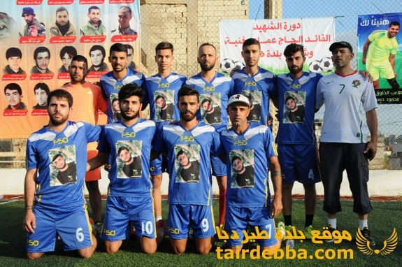 Soccer team named after a Hezbollah shahid whose picture appears on the team’s uniform. The sign in the background reads, “Tournament of the shahid commander Al-Hajj Imad (?)…” (Facebook page of the village of Tair Debba in southern Lebanon, July 9, 2016).