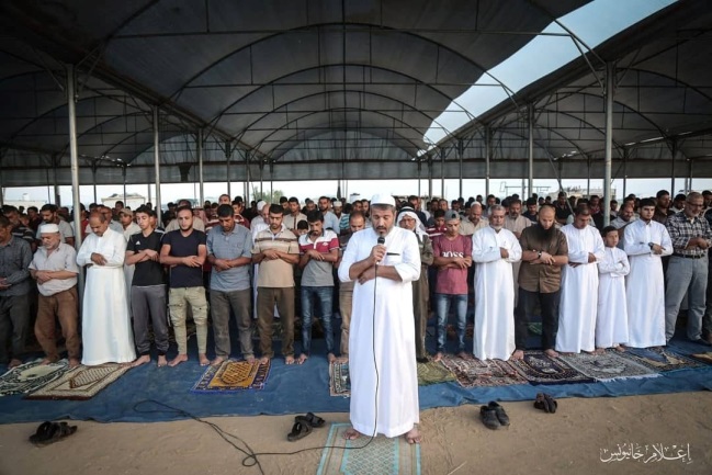 Mass prayer in the return camp in eastern Khan Yunis.