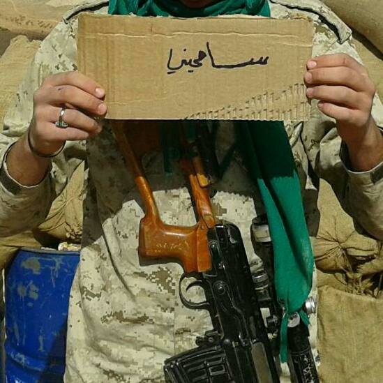 Operative of Hezbollah’s military wing holding a sign that reads, “Forgive me” (asking for his mother’s forgiveness because he may not return from battle) (Facebook). 