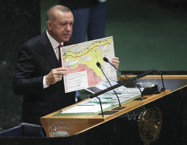 Turkish President Erdogan holds a map of the planned 