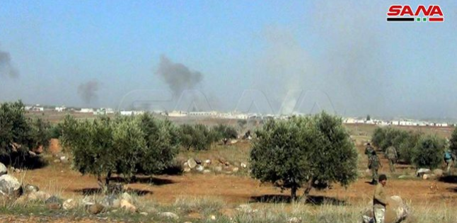 Dust and smoke rising from the village of Al-Tah, the stronghold of the Headquarters for the Liberation of Al-Sham, taken over by the Syrian army and the Russian fighter jets (SANA, December 22, 2019)