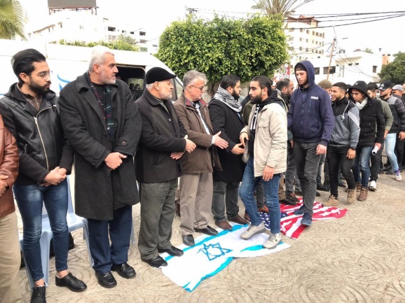 Des visiteurs piétinent des drapeaux israéliens et américains à l'entrée de la tente de deuil (Compte Twitter d'Ali Shoeib, 4 janvier 2020).